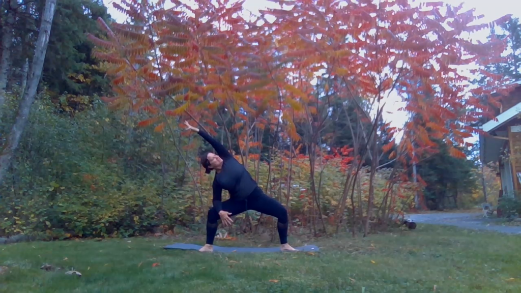 Goddess Squat with side stretch in a fall setting.